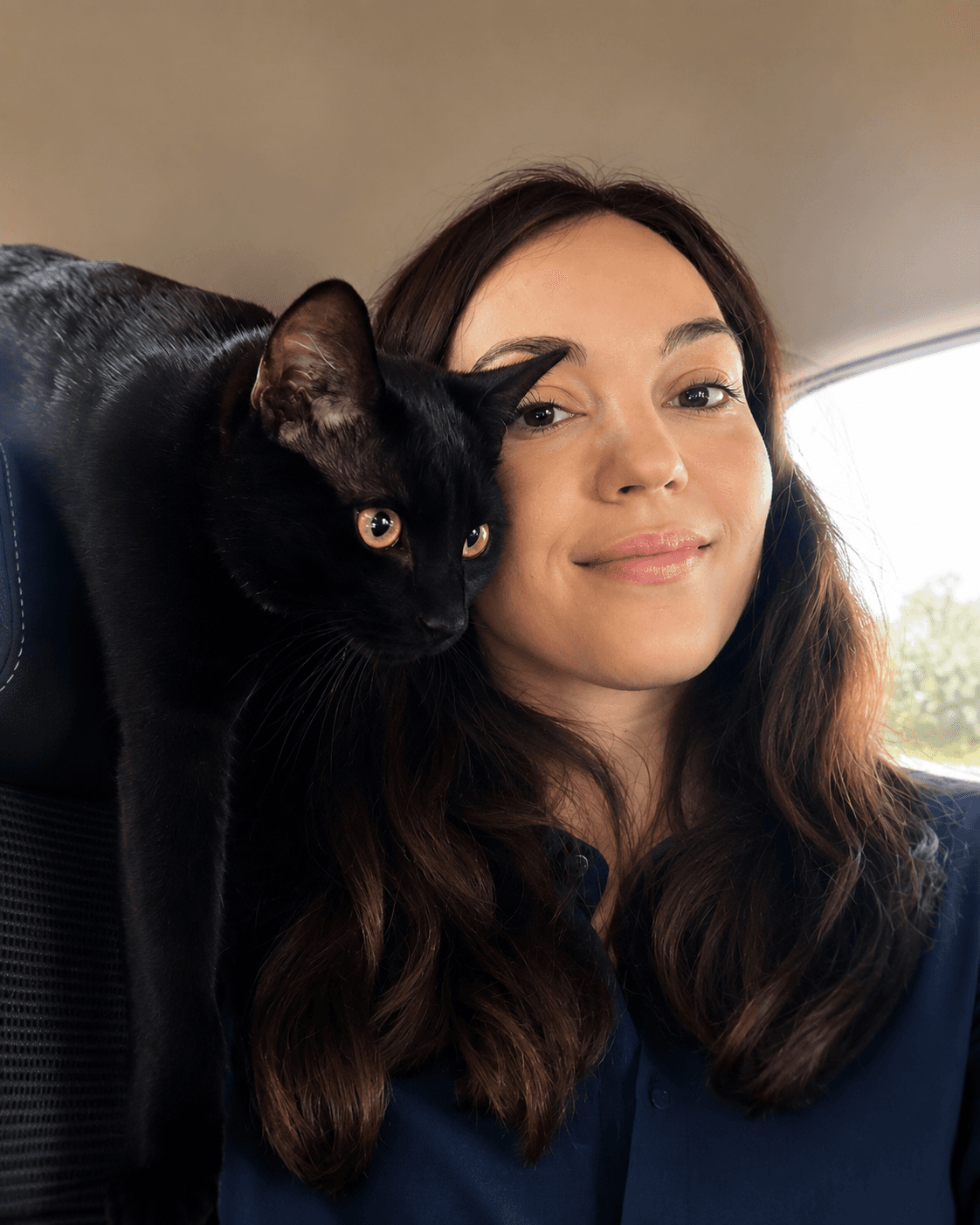 Ralitsa, founder of Pet Shenanigans, with Kiwi the cat
